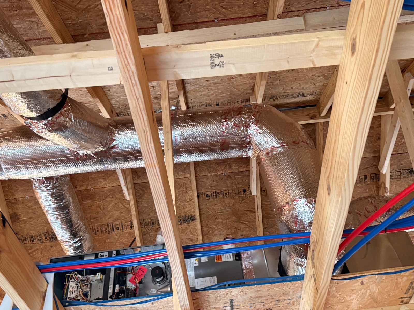 HVAC ductwork and equipment within exposed roof framing