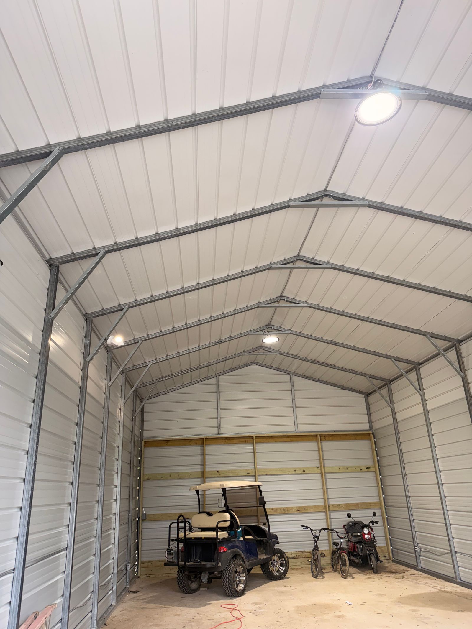 Overhead lighting inside a metal workshop from the MHA project collection